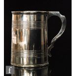 A Victorian hallmarked silver pint tankard with part ribbed decoration and C scroll handle,