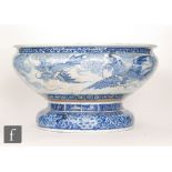 A large 20th Century blue and white footed jardiniere decorated to the exterior with stylised