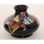 A Moorcroft vase of compressed form decorated in the Frilled Orchid pattern with tubelined flowers