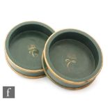 A pair of 20th Century green painted bottle coasters, each interior painted 'C' below a crown,