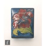 A Moorcroft Pottery rectangular box and cover decorated in the Clematis pattern with a single