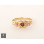 An early 20th Century 18ct hallmarked garnet, red spinel and diamond boat shaped ring,