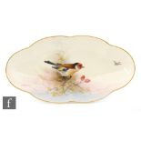 A Royal Worcester oval shaped scalloped edge dish decorated by E.