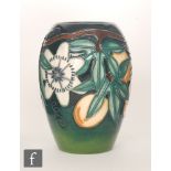 A small Moorcroft Pottery vase decorated in the Passion Fruit pattern designed by Rachel Bishop,