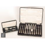An early 20th Century cased set of knives and forks with hallmarked silver handles with moulded