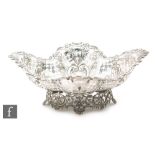 A Victorian hallmarked silver shaped oval bread basket with pierced sides and scrolled detail to