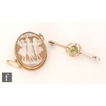 An early 20th Century 9ct single stone peridot bar brooch, with a 9ct cameo brooch. (2).