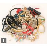 A small parcel lot of assorted mid 20th Century costume jewellery to include beads, brooches,