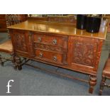 An early 20th Century carved oak sideboard,