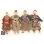 A group of four late 19th Century Chinese opera dolls with composition heads with painted features,