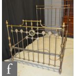 A late 19th Century brass double bed,