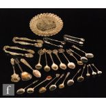 A collection of silver and white metal commemorative spoons,