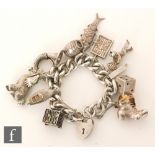 A hallmarked silver curb link charm bracelet with several chrams attached, total weight 163g.