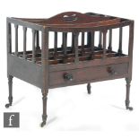 A George IV mahogany four divisioned Canterbury with base drawer on ring turned legs,