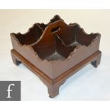 A 19th Century four divisioned mahogany wine carrier with wavy edge border and centre handle on