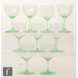 A set of six uranium green wine glasses with round funnel bowls with an acid etched band of ovals