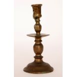 A single 17th Century style bronze candlestick with central drip pan below the sconce and turned