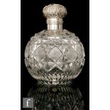 An Edwardian hallmarked silver and clear cut glass globular scent bottle with part diamond cut body