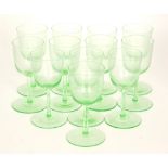 A set of 12 Edwardian uranium green round funnel bowl basal cut wine glasses, height 12.5cm.