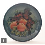 A Moorcroft Pottery plate decorated in the Finches pattern designed by Sally Tuffin, impressed mark,