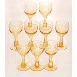 A set of nine late 19th Century amber wine glasses with ovoid bowls and integral hollow slice cut