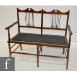 An Edwardian three piece drawing room suite comprising of a two seater seater settee and two chairs