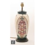 A Moorcroft Pottery table lamp decorated in the Foxglove pattern designed by Rachel Bishop,