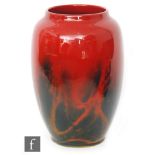 An early 20th Century Royal Doulton Flambe Sung vase of swollen tapering form decorated mottled and