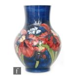 A large Moorcroft vase of footed globe and shaft form decorated in the Frilled Orchid pattern with