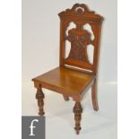 A Victorian carved walnut hall chair,