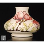 A large Moorcroft vase of compressed form decorated in the Magnolia pattern with tubelined pink