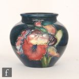 A Moorcroft vase of ovoid form with a roll rim neck decorated in the Frilled Orchid pattern with