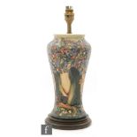 A Moorcroft Pottery table lamp decorated in the Knightwood pattern designed by Rachel Bishop,