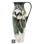 A tall Moorcroft Pottery jug decorated in the Snowdrift (from the Christmas Collection) pattern