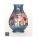 A small Moorcroft Pottery baluster vase decorated in the Anemone pattern,