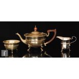 A hallmarked silver bachelor's three piece tea set of faceted circular form,