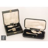Two cased hallmarked silver children's feeding sets with pusher and spoon,