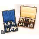 A Georgian cased set of six spoons and a pair of tongs, fiddle pattern with monogram to terminals,