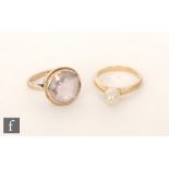 A 9ct single stone amethyst ring, with a similar freshwater pearl example. (2).