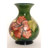 A Moorcroft Hibiscus pattern vase of compressed ovoid form with a flared neck decorated with