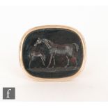 A 19th Century 18ct fob with central red stone intaglio carved with a horse and foal,