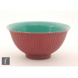 A Chinese magenta glazed lobed bowl of circular form with ribbed exterior sides,