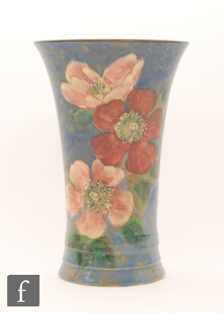 A 1930s Royal Doulton Wild Roses flared vase decorated with painted roses against a mottled blue