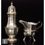 A Victorian hallmarked silver cream jug with scalloped edges,