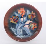 A Moorcroft Pottery Red Tulips pattern shallow dish designed by Sally Tuffin decorated with a spray