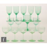 A set of five uranium green wine glasses, the round funnel bowls engraved with fruiting vines,
