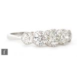 A platinum diamond five stone ring, graduated brilliant cut, claw set stones,