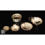 Three hallmarked silver shell shaped butter dishes each raised on three feet, largest 13cm long,