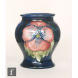 A Moorcroft vase of inverted baluster form with a wide neck decorated in the Pansy pattern with two