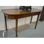 A late Georgian mahogany console table or table end section of rounded rectangular form,